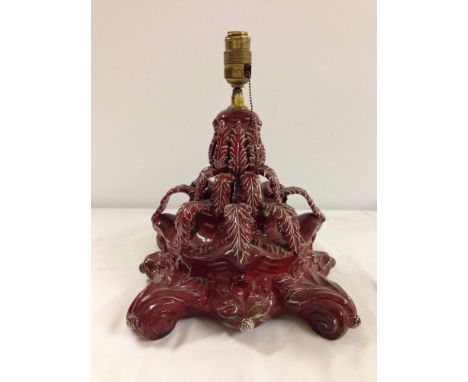 An antique continental majolica table lamp in red glaze, approx 33cm tall.