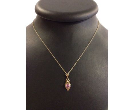 Pretty 9ct gold pendant set with 0.5ct pink sapphire and small diamond. Approx 2.5cm long on a 20" 9ct gold chain. Total weig