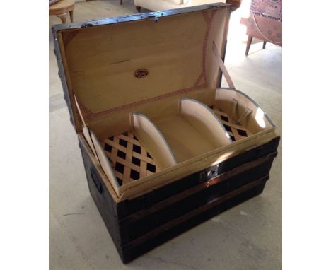 A vintage John Pound & Co London travelling trunk of wood construction with original black outer covering, internal tray and 