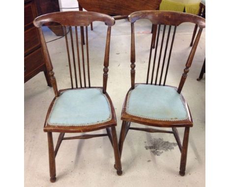 A pair of vintage stick back chairs.