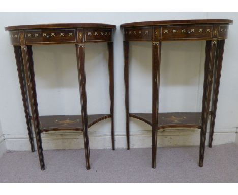 A pair of early 20thC rosewood semi-circular lamp tables, each with neo-classical marquetry ornament and a frieze drawer, rai