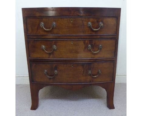 A Georgian style mahogany bow front chest, the three graduated long drawers with cock beading and brass bail handles, raised 