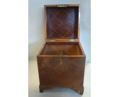 A George III flame veneered and satinwood string inlaid mahogany cube shaped tantalus with flank brass bail handles and a loc