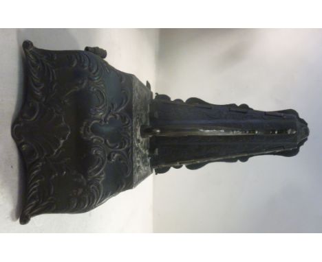 A late 19thC Continental pewter finished alloy cased metronome, decorated with cast foliate, shell and latticed designs, the 