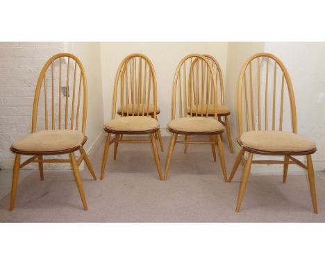 A set of six Ercol pale coloured beech and elm framed Windsor style, high hoop, spindled back dining chairs with solid seats 