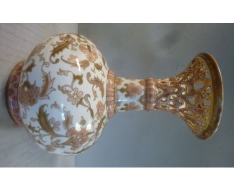 A Zsolnay Pecs porcelain bottle vase of squat, bulbous form with a waisted, narrow neck and a reticulated, flared rim, decora