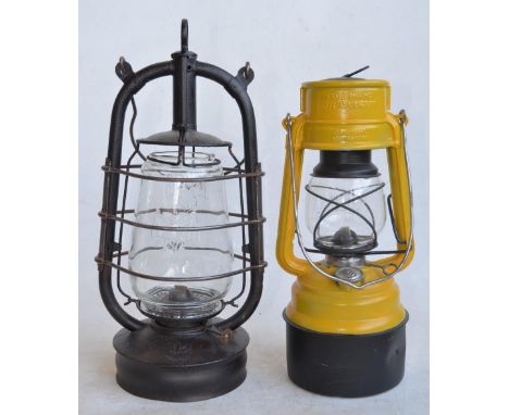 Two vintage German paraffin storm lamps to include a Bat lamp (metal body stamped Made In Thuringia, glass shade Made In Engl
