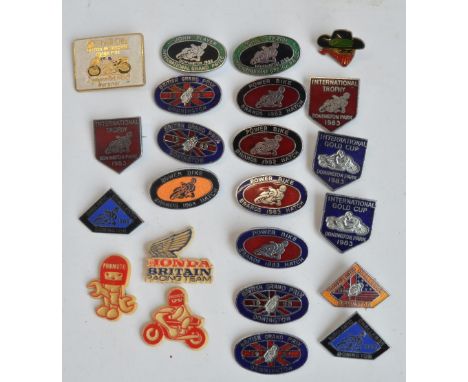 Twenty three motorbike racing related pin badges to include 20 enamel badges for the British Grand Prix and International Gol