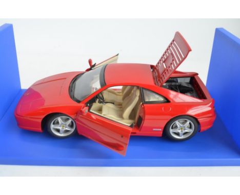 Three boxed 1/18 scale highly detailed diecast car models to include UT Models McLaren F1 GTR,  Ferrari F355 Berlinetta and a