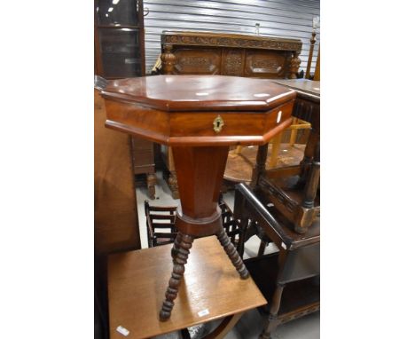 A 19th Century sewing table having fitted interior , on interesting bobbin turned legs