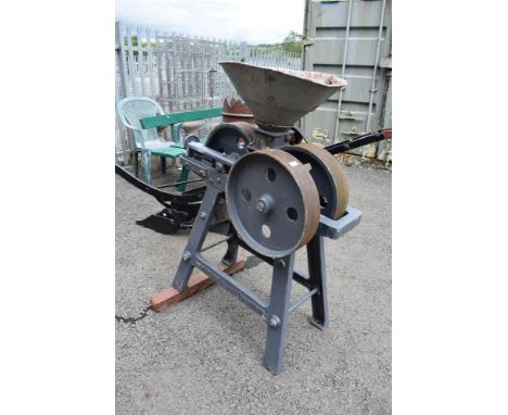 A vintage belt driven grain roller