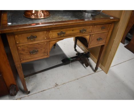 An early 20th century Sheraton style writing desk having shelf and cupboard back with fitted interior and inlayed details on 