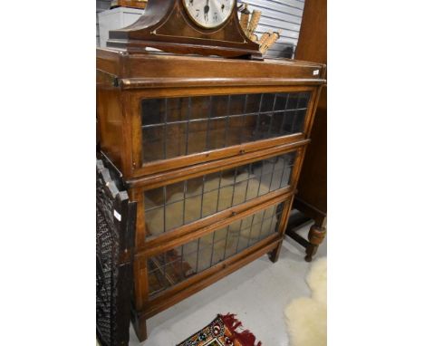 An early 20th century Globe Wernicke three section bookcase with leaded light doors