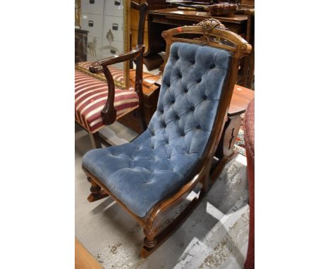A Victorian nursing rocking chair with button back upholstery
