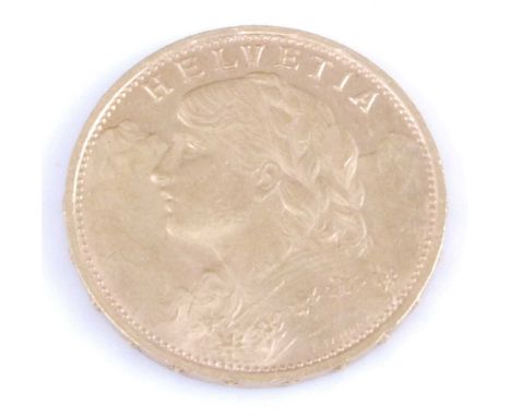 Switzerland, 1930 gold 20 franc coin, obv; female portrait wearing garland facing left, rev; shield bearing cross within oak 