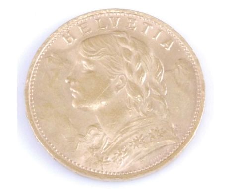 Switzerland, 1930 gold 20 franc coin, obv; female portrait wearing garland facing left, rev; shield bearing cross within oak 