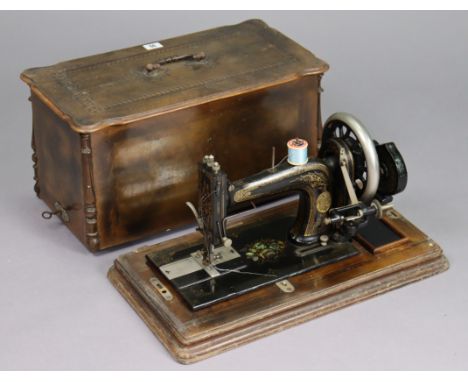A vintage hand sewing machine bears plaque “T. Rhodes and Sons of Silver St Halifax”, with case.
