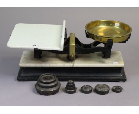 A set of vintage shop’s counter-top scales mounted on an ebonised wooden plinth inset with white marble, 20½” wide; &amp; a s