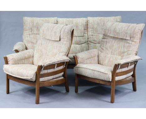 An Ercol elm four-piece lounge suite comprising of a three-seater settee with loose cushions to the seats &amp; backs, 76” lo