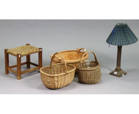 A brass Corinthian-style table lamp base with shade, together with a string-seat stool, three wicker baskets, and a glass car