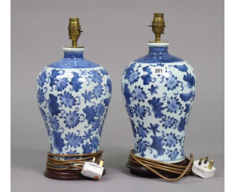 A pair of blue and white table lamp bases of bulbous form and with foliate decoration, 13” high, lacking shades.