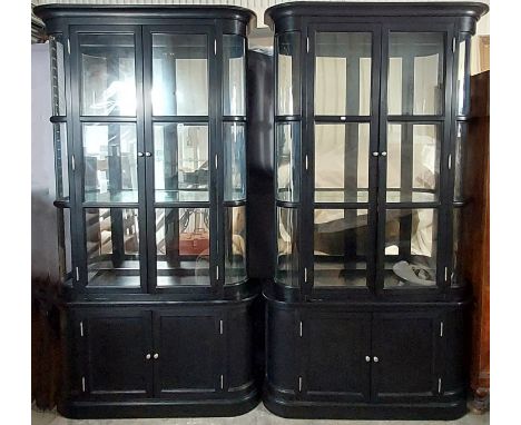 A PAIR OF CONTEMPORARY EBONISED-FINISH TALL CHINA DISPLAY CABINETS, PURCHASED FROM INDIA JANE OF BATH (each in two sections) 