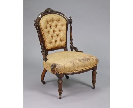 A 19th century carved beach-frame buttoned-back nursing chair (requires upholstery), on short turned &amp; fluted legs with c