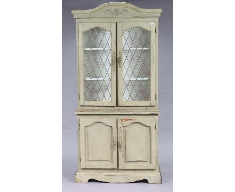 A continental-style light grey painted wooden tall cabinet the upper part fitted two shelves (lacking glass inserts) enclosed