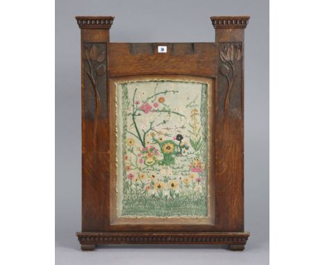 An early 20th century carved oak-frame firescreen inset embroidered floral panel, 24¾” wide 33¾” high.