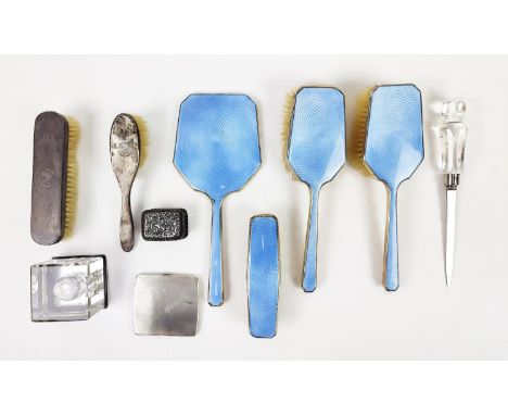 AN ART DECO SILVER AND BLUE ENAMELLED DRESSING TABLE BRUSH SET, plus an ink well, cigarette case, patch box. (Qty)