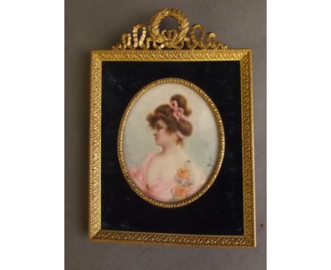 A late C19th/early C20th miniature portrait on ivory of a lady in a pink gown, signed Rochat, in a brass empire frame, 2½'' x