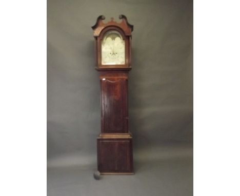 An early C19th figured mahogany and oak long case clock, the painted arched dial with sun and moon roller movement, Arabic nu