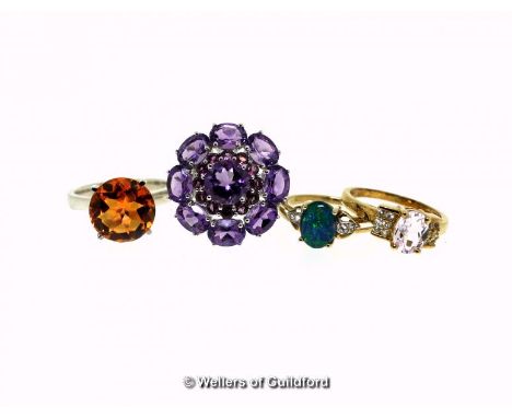 Four gem set dress rings, including an amethyst and garnet cluster ring, ring S, an orange quartz ring, ring size S, an opal 