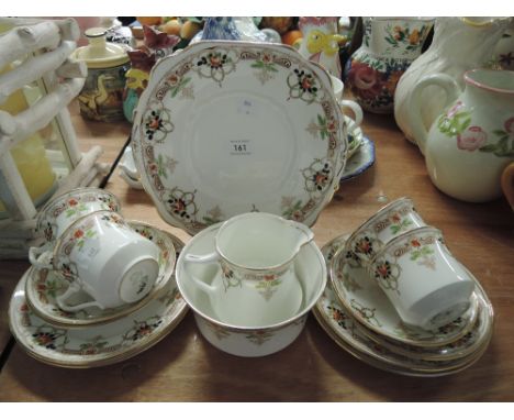 A vintage hand decorated part tea service