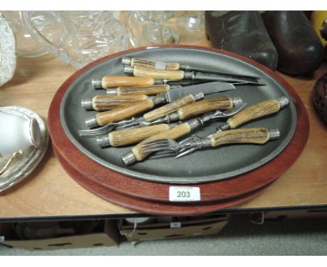 A selection of vintage steak plates and cutlery