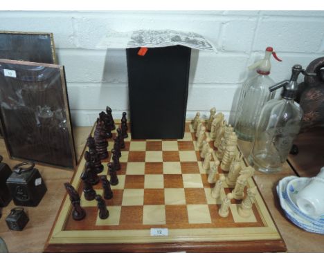 A vintage chess set by Studio Anne Carlton, Alice through the looking glass with treen wood board. Proceeds for charity