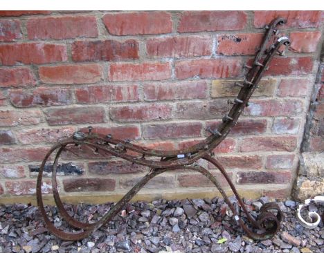 A pair of Victorian iron bench ends with scrolled detail 