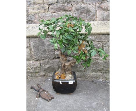 A simulated bonsai tree in a Chinese ceramic pot, together with a cast iron boot beetle 