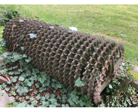 A cast iron agricultural roller, the central bar supporting 24 individual circular panels each with dog tooth borders (these 
