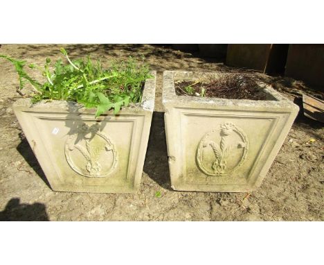 A pair of square cut urns with fleur-de-lys detail, the bench 130 cm in length