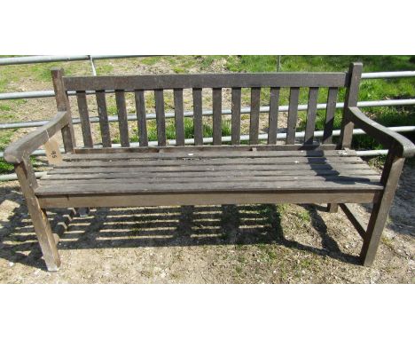 A teakwood garden bench 152 cm long, together with a matching teakwood two tier occasional table, the timbers taken from SS O