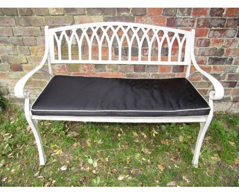 A decorative aluminium garden bench with lattice work back, scrolled arms and cushion, 120cm wide 