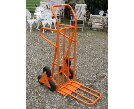 An unusual sack trolley with step climbing wheels