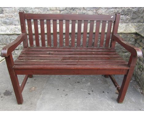 A teakwood garden bench with slatted seat and back 120 cm wide 