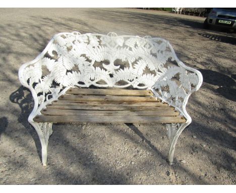 A cast aluminium garden bench in the Colebrookdale style depicting ferns and blackberries and with teak seat, 110 cm wide 