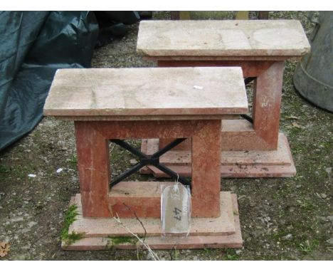 A pair of marble bench ends with iron work x framed centres, 48 cm wide x 43 cm in height (AF) 