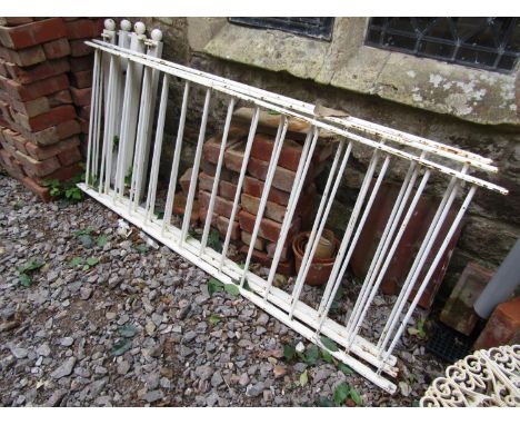 Three sections of cast iron railing with simple vertical solid tubular bars and 4 square posts with ball finials, each sectio
