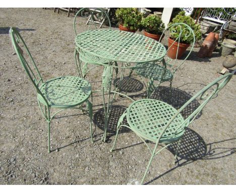 Circular metal terrace table, 71cm diameter raised on four shaped supports, together with a matching set of four chairs, all 