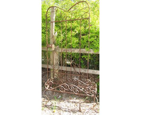 An iron work pedestrian gate with scrolled detail, 985 cm wide (excluding hinge fitting), 190 cm in height, together with a r