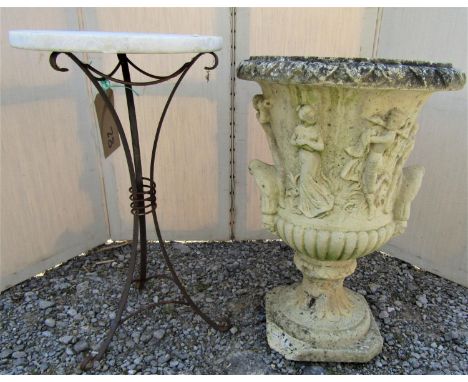 A small ironwork tripod table with circular marble top, 33cm diameter, together with a garden urn with classical detail, 57cm